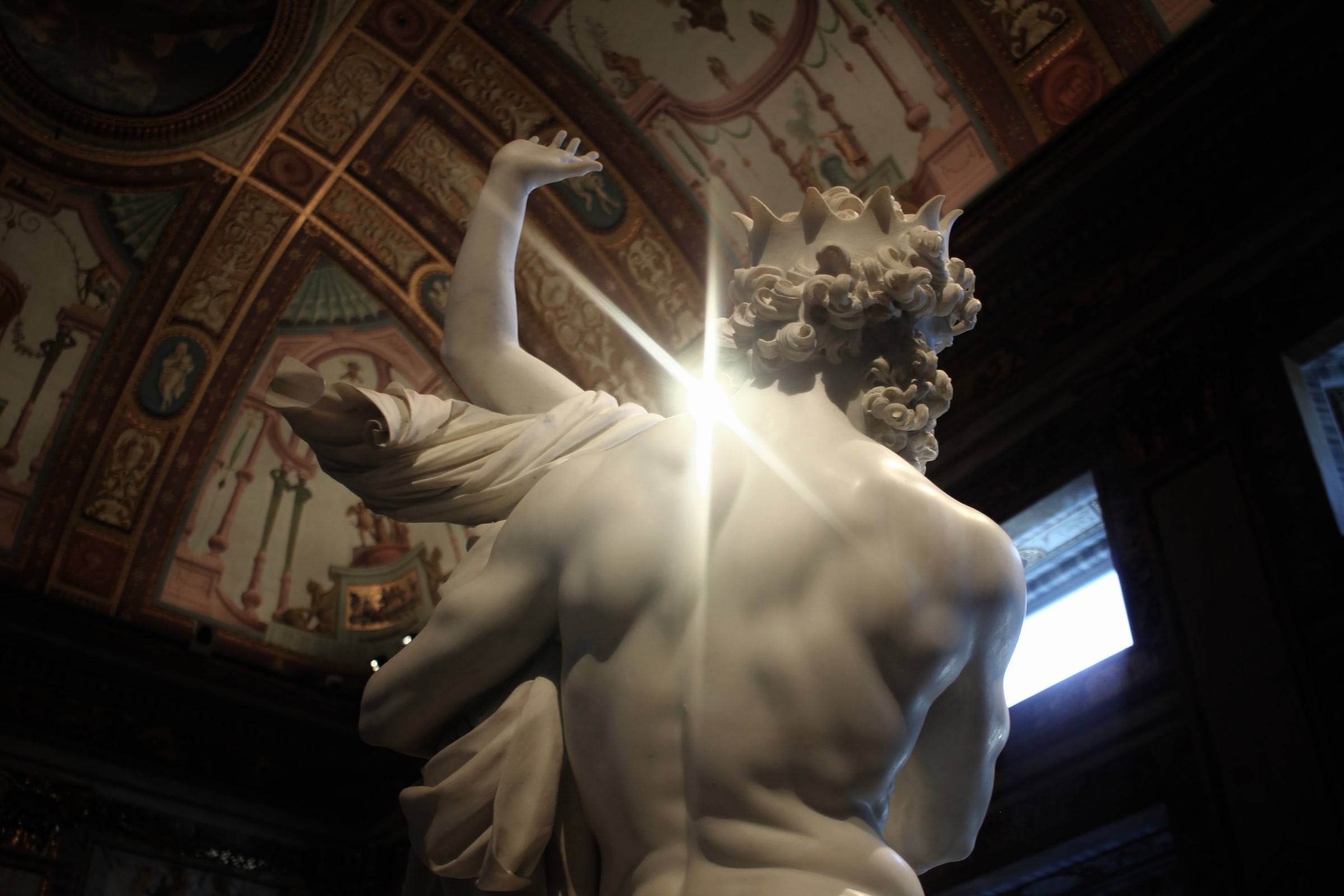 Bernini's Apollo and Daphne seen from below, laurel breaking from her raised hand.